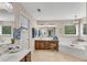 Luxurious bathroom with a soaking tub, double vanity and a decorative chandelier at 3665 Evonvale Gln, Cumming, GA 30041