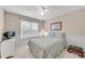 Cozy bedroom featuring neutral walls and carpet, complemented by a ceiling fan and a window with blinds at 3665 Evonvale Gln, Cumming, GA 30041