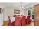 Traditional dining room with hardwood floors, tray ceiling, and seating for eight at 3665 Evonvale Gln, Cumming, GA 30041