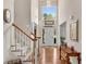 Bright foyer with hardwood floors, staircase, and a view of the front door and entry at 3665 Evonvale Gln, Cumming, GA 30041