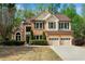 Charming two-story brick home with a well-manicured lawn and an attached two-car garage at 3665 Evonvale Gln, Cumming, GA 30041