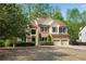 Attractive two-story home with brick and siding, a two-car garage, and mature landscaping at 3665 Evonvale Gln, Cumming, GA 30041