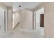 Neutral hallway featuring carpet floors and white walls, with doorframes leading to other rooms at 3665 Evonvale Gln, Cumming, GA 30041