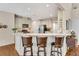 Well-lit kitchen featuring an island with barstool seating, ample counter space, and stainless steel appliances at 3665 Evonvale Gln, Cumming, GA 30041