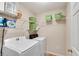 Convenient laundry room with washer, dryer, and wire shelving for storage at 3665 Evonvale Gln, Cumming, GA 30041