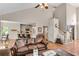 Spacious living room featuring hardwood floors, and open access to the kitchen and breakfast nook at 3665 Evonvale Gln, Cumming, GA 30041