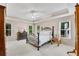 Well-lit bedroom with neutral carpet, windows, ceiling fan and tray ceiling, with coordinated lamps and bedroom furniture at 3665 Evonvale Gln, Cumming, GA 30041