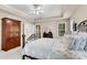Spacious bedroom with ample natural light and ceiling fan overlooking a decorative bed and wood furniture at 3665 Evonvale Gln, Cumming, GA 30041
