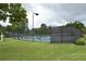 Community tennis court surrounded by a black fence provides a dedicated space for residents to enjoy tennis and outdoor activities at 3665 Evonvale Gln, Cumming, GA 30041