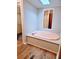 Bathroom featuring a soaking tub with wood-look flooring and a built-in shower at 3735 Fir Dr, Buford, GA 30518