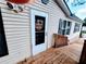 This lovely home has a bright white front door and wood deck at 3735 Fir Dr, Buford, GA 30518