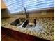 Kitchen sink with stainless steel faucet, double basin, and granite countertops at 3735 Fir Dr, Buford, GA 30518