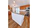 Kitchen island with cabinets, pendant lighting, and stainless steel appliances at 3735 Fir Dr, Buford, GA 30518