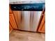 Stainless steel dishwasher in the kitchen with wooden cabinets and a hard wood floor at 3735 Fir Dr, Buford, GA 30518