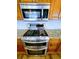 Modern kitchen features stainless steel appliances, granite countertops, and wooden cabinets at 3735 Fir Dr, Buford, GA 30518