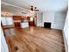 Open floor plan with wood floors, kitchen island, and a fireplace with built-in shelving at 3735 Fir Dr, Buford, GA 30518