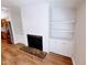 Cozy living room with built-in shelving and a fireplace at 3735 Fir Dr, Buford, GA 30518