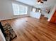 An open-concept living room features wood floors and a fireplace with stone surround at 3735 Fir Dr, Buford, GA 30518