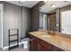 Modern bathroom with a vanity, sink, and a glass enclosed shower with dark gray walls at 860 Peachtree Ne St # 1417, Atlanta, GA 30308
