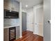 Hallway featuring a wine cooler, modern light fixtures, and hardwood floors at 860 Peachtree Ne St # 1417, Atlanta, GA 30308
