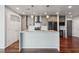 Modern kitchen featuring a large island, stainless steel appliances, and beautiful hardwood floors at 860 Peachtree Ne St # 1417, Atlanta, GA 30308