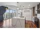 The kitchen features a large island with pendant lighting, quartz countertops, and stainless appliances at 860 Peachtree Ne St # 1417, Atlanta, GA 30308