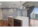 Contemporary kitchen island with quartz countertop, stainless steel sink, and hardwood floors at 860 Peachtree Ne St # 1417, Atlanta, GA 30308