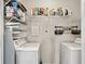 Bright laundry room with shelving and side-by-side washer and dryer units at 860 Peachtree Ne St # 1417, Atlanta, GA 30308