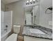 Bathroom featuring a shower-tub combo, granite countertop, and modern fixtures at 1550 Royale Castle Dr, Lawrenceville, GA 30043