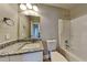 Bathroom with granite countertop, single vanity, and shower-tub combo at 1550 Royale Castle Dr, Lawrenceville, GA 30043