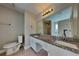 Bathroom with granite countertop, double vanity, tile floors, and modern lighting at 1550 Royale Castle Dr, Lawrenceville, GA 30043