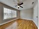Bedroom featuring a ceiling fan, hardwood floors and a large window with blinds at 1550 Royale Castle Dr, Lawrenceville, GA 30043