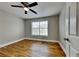 Bedroom featuring a ceiling fan, hardwood floors and a large window with blinds at 1550 Royale Castle Dr, Lawrenceville, GA 30043