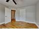 Bedroom featuring hardwood floors, neutral paint, and convenient access to other rooms at 1550 Royale Castle Dr, Lawrenceville, GA 30043