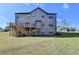 Backyard with a deck and stair access; ideal for outdoor living and enjoying the surrounding green space at 2705 Fox Hunt Way, Cumming, GA 30041