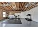 Home gym featuring workout equipment, rubber floor mats, and an egress window for safety and natural light at 2705 Fox Hunt Way, Cumming, GA 30041