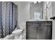 Clean bathroom with a shower, a toilet, and a vanity with drawers at 2705 Fox Hunt Way, Cumming, GA 30041