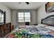 Relaxing bedroom with a large window, a wooden bed, and a dresser at 2705 Fox Hunt Way, Cumming, GA 30041