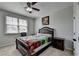 Cozy bedroom with a ceiling fan, a window, and dark wood furniture at 2705 Fox Hunt Way, Cumming, GA 30041