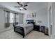 Cozy bedroom features neutral tones, a ceiling fan, and ample natural light from the window at 2705 Fox Hunt Way, Cumming, GA 30041