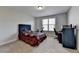 Neutral bedroom features a comfortable bed, carpet floors and a window to let in natural light at 2705 Fox Hunt Way, Cumming, GA 30041