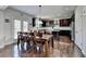 Spacious dining area featuring a wooden table with chairs and hardwood floors and lots of light at 2705 Fox Hunt Way, Cumming, GA 30041