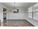 Elegant dining room features hardwood floors, wainscoting, and a chandelier at 2705 Fox Hunt Way, Cumming, GA 30041