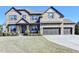 Handsome two story brick home with three car garage and professionally landscaped front yard at 2705 Fox Hunt Way, Cumming, GA 30041
