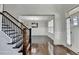 Welcoming foyer features hardwood floors, staircase with iron spindles, and a view into the dining room at 2705 Fox Hunt Way, Cumming, GA 30041