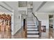 Grand foyer with hardwood floors, staircase with iron spindles, and wainscoting at 2705 Fox Hunt Way, Cumming, GA 30041