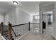 Upstairs hallway with wooden handrail at 2705 Fox Hunt Way, Cumming, GA 30041