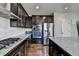 Beautiful kitchen features wood floors, stainless appliances and large island with granite countertops at 2705 Fox Hunt Way, Cumming, GA 30041