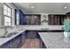 Well-appointed kitchen with dark brown cabinets, granite countertops, and stainless steel appliances at 2705 Fox Hunt Way, Cumming, GA 30041
