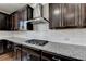 Gourmet kitchen features dark wood cabinets, granite countertops and stainless steel appliances at 2705 Fox Hunt Way, Cumming, GA 30041